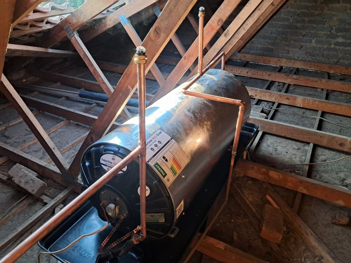 New Superline 600 Dual geyser in a roof space on a drip tray, with copper pipework and vacuum breakers